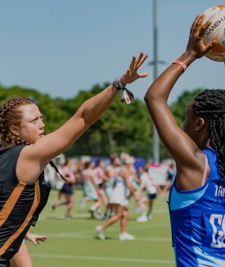 Two girls playing netball