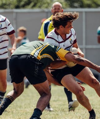 A rugby player being tackled