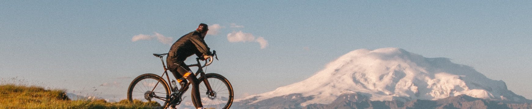 a cyclist looking at a mountain in the horizon