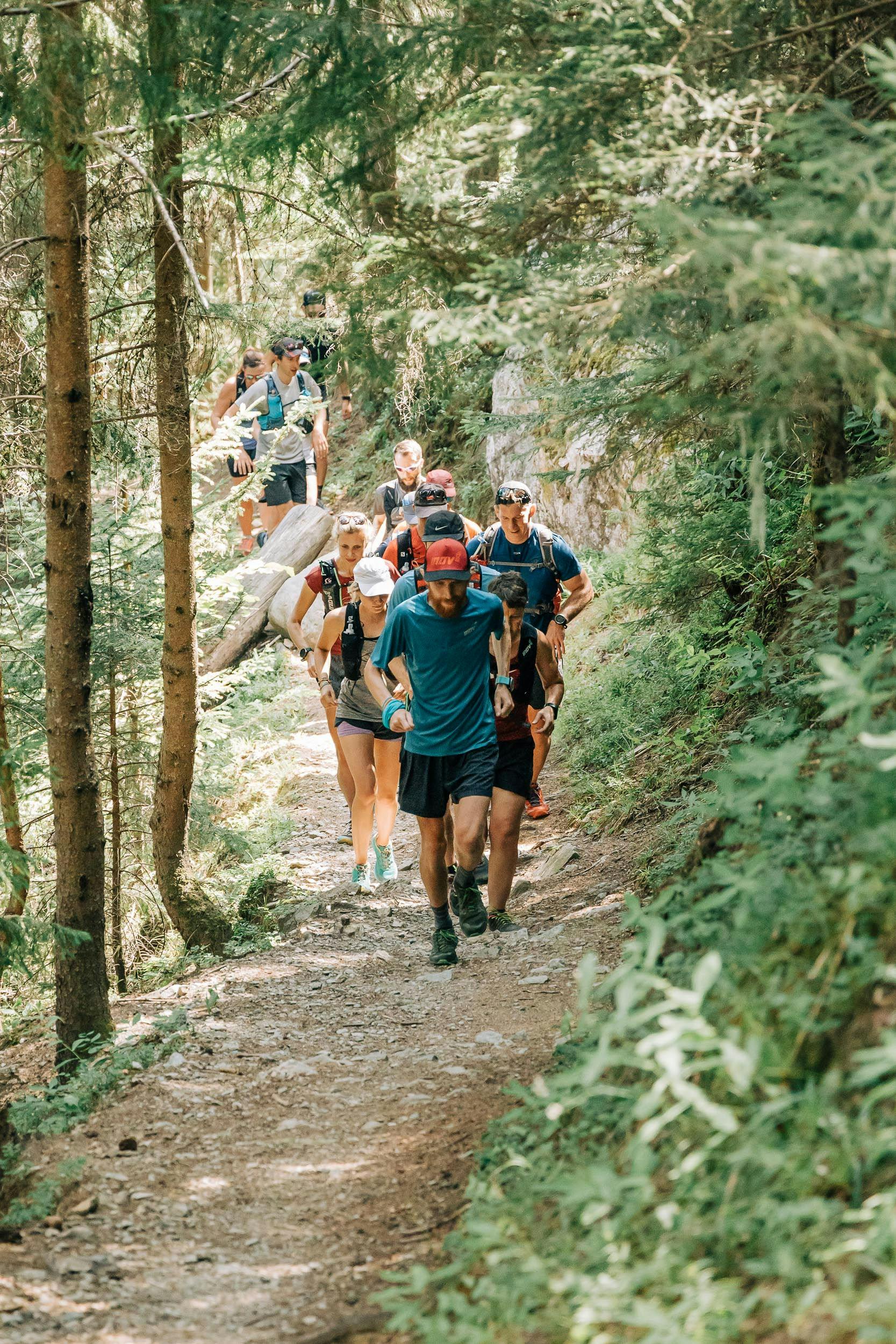 a group of trail runners in the forest