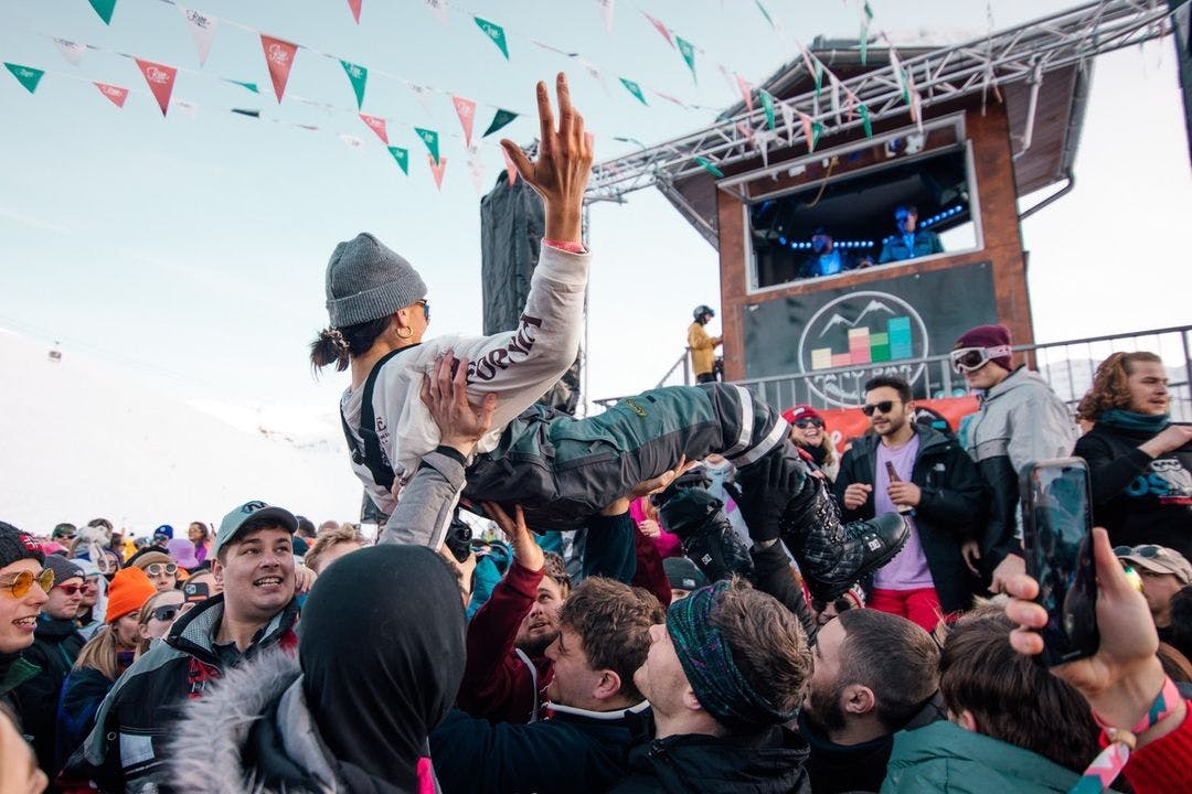 a girl crowdsurfing at a festival