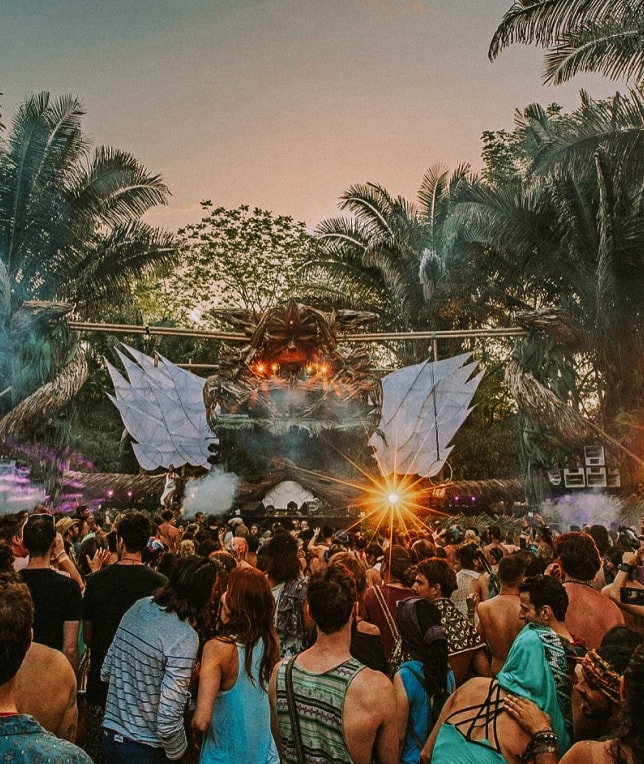 people having fun at a festival in a tropical forest