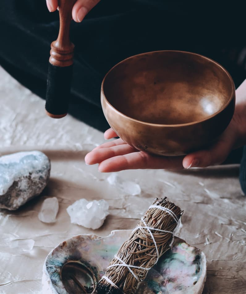 A traditional singing bowl surrounded by crystals