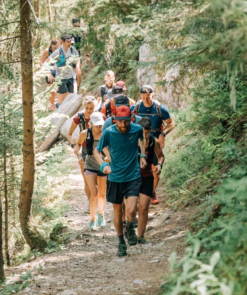 A group of trail runners race through the mountains